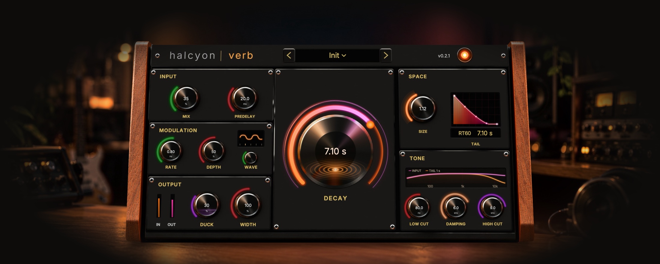 Halcyon Verb on a walnut desk in a dim studio. The window: a brushed-metal console between walnut sides. A large vinyl-like Decay dial with a glowing orange-to-pink arc sits in the middle at 7.1 seconds; Input, Modulation and Output knobs on the left, Space and Tone on the right, each knob ringed by a neon arc.